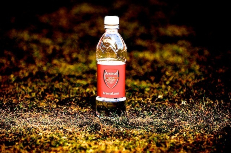 A bottle of water with the Arsenal logo